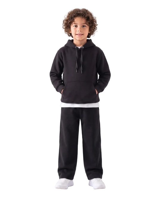 Front view of a young boy wearing a black milton hoodie by TREE.