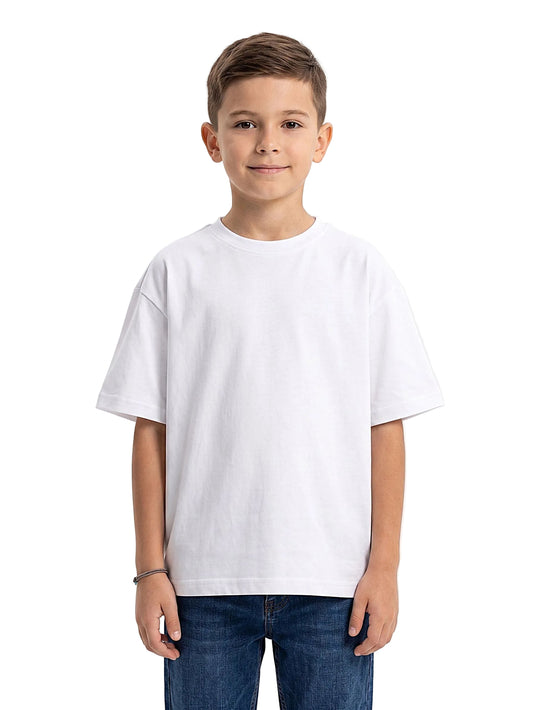 A young boy wearing a plain white short-sleeve crewneck t-shirt and blue jeans, standing against a solid white studio background.