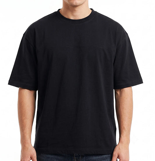 A man wearing a black short-sleeve crewneck t-shirt, shown from the neck down against a plain white background.