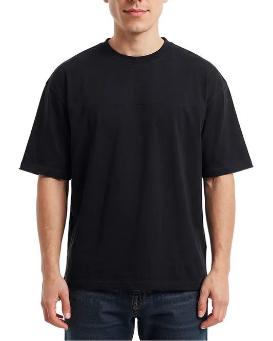 A man wearing a black short-sleeve crewneck t-shirt, shown from the neck down against a plain white background.