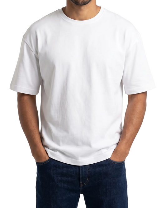 A man wearing a plain white short-sleeve crewneck t-shirt and dark blue jeans, standing against a light gray background.