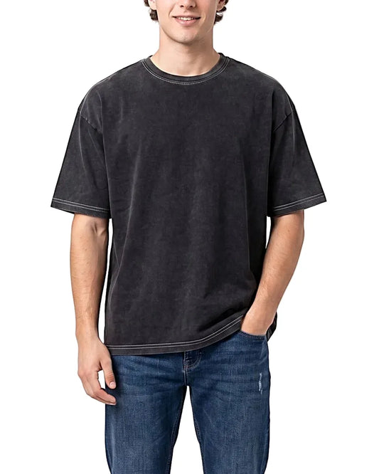 Young man modeling a Men's washed charcoal black box fit t-shirt featuring contrast stitching, paired with blue jeans.