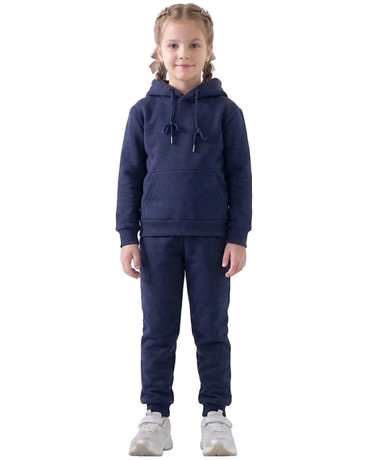 Front view of a young girl wearing navy pants in a relaxed fit by TREE.