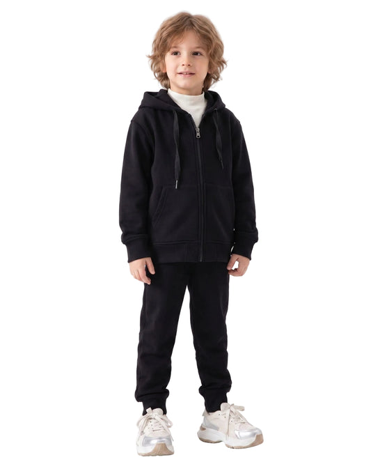 Side view of a boy wearing a black milton full-zip hoodie in a relaxed fit by TREE.