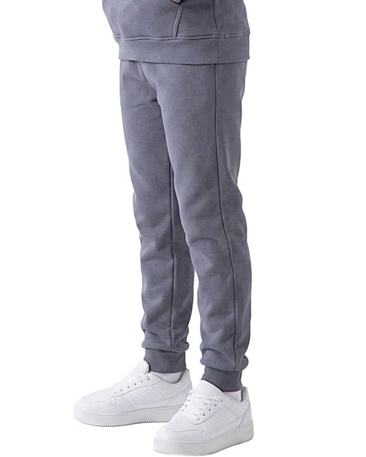 Front view of a young girl wearing dark grey milton pants in a relaxed fit by TREE.