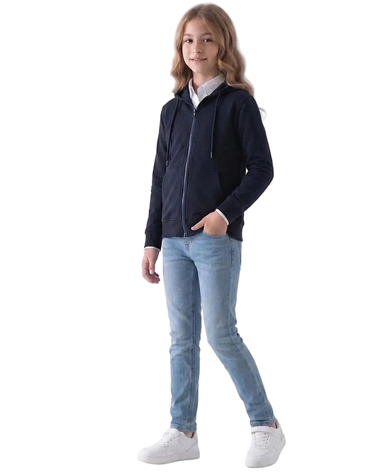 Side view of a girl wearing a girls' milton navy zip-up hoodie (100% cotton) featuring a hood and front pockets by TREE.
