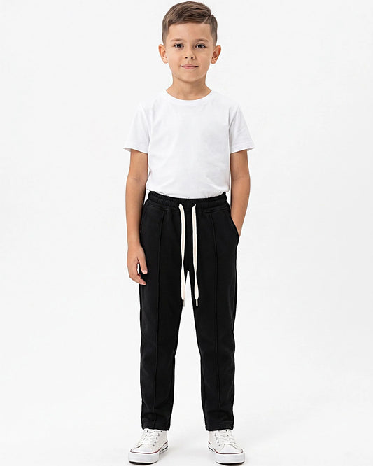 Front view of a boy wearing boys' sweatpants with an elastic waist by TREE.