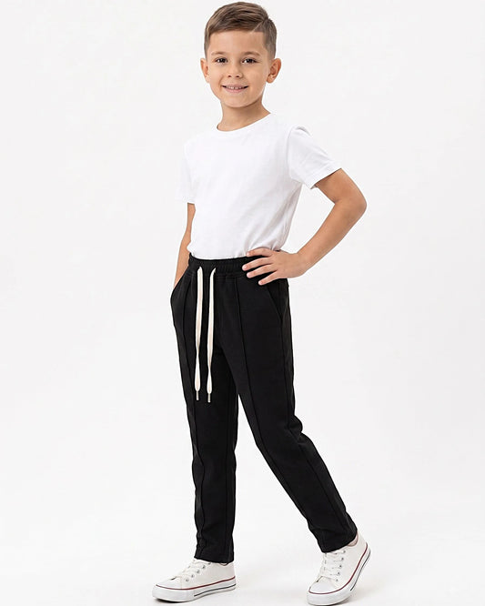 Front view of a boy wearing boys' sweatpants with an elastic waist by TREE.