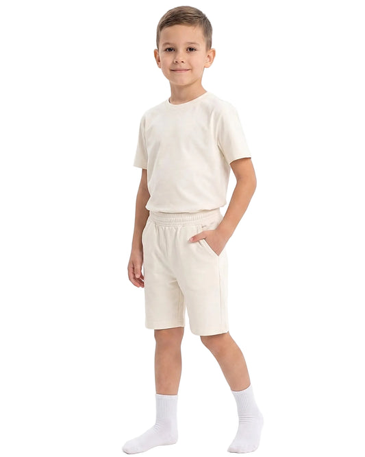 Front view of a boy wearing a kids' summer 100% cotton t-shirt and shorts outfit set by TREE.