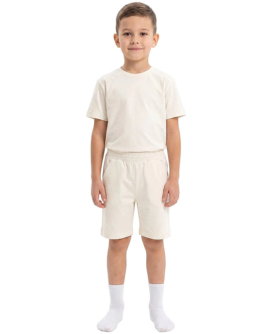 Front view of a boy wearing a kids' summer 100% cotton t-shirt and shorts outfit set by TREE.