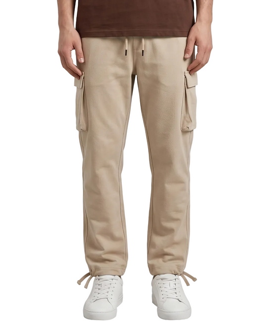 Person wearing beige cargo pants with a plain background