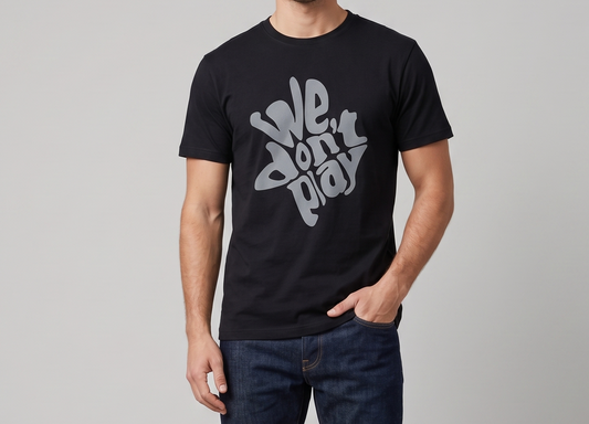 Person wearing a black t-shirt with 'We Don't Play' text on a plain background