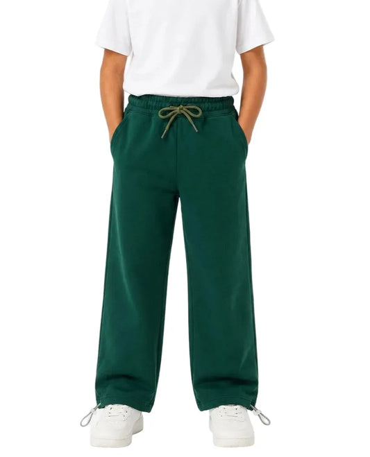 Multiple views of a boy wearing dark green summer milton wide-leg sweatpants with side pockets and a drawstring waist by TREE.