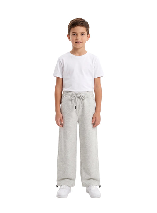 Full-length view of boy wearing TREE light grey relaxed wide-leg sweatpants and white t-shirt