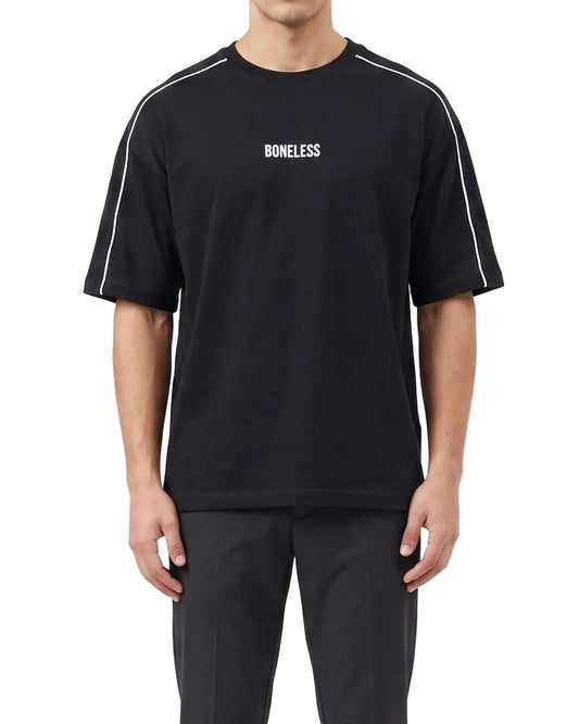 A male model wearing a men's oversized black t-shirt featuring a white BONELESS print on the chest and white shoulder piping.