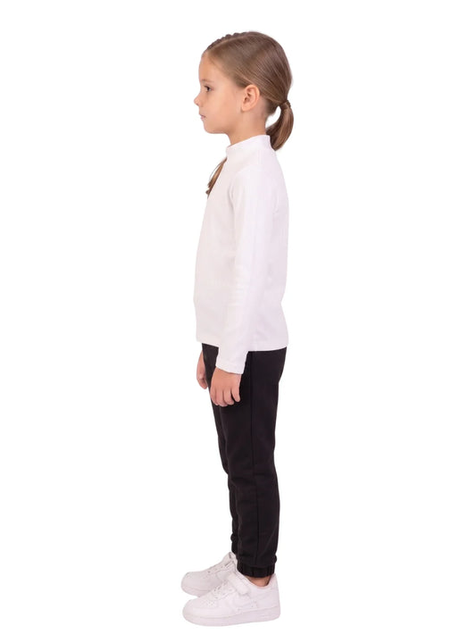 Side profile of a young girl wearing a white long-sleeve high-neck basic top from TREE