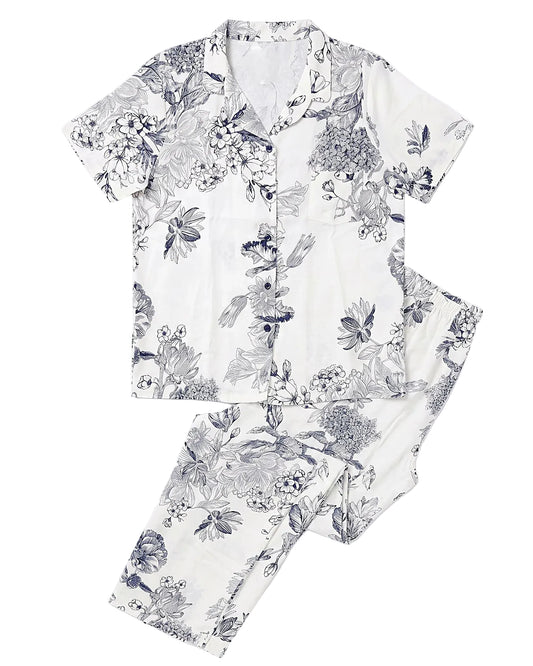 Front view of a women's 100% viscose pajama set featuring a navy floral print in a relaxed fit by TREE.