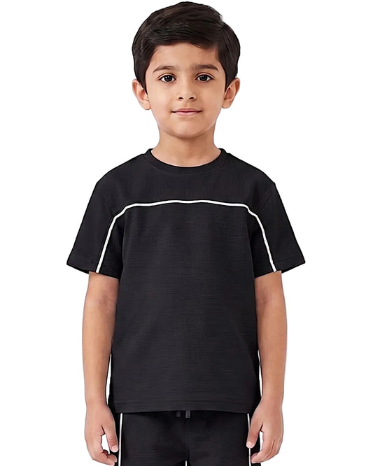 A young boy wearing a black short-sleeve t-shirt with a white curved stripe detail across the chest, standing against a plain white background.