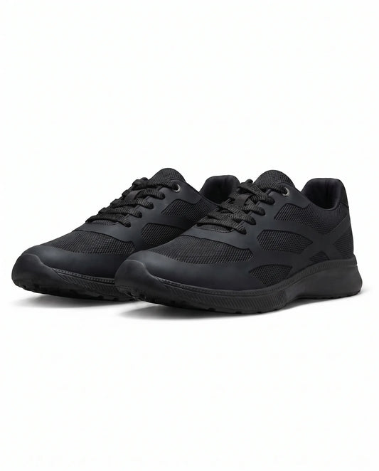 Boys' solid black athletic sneakers with visible texture and mesh details from TREE