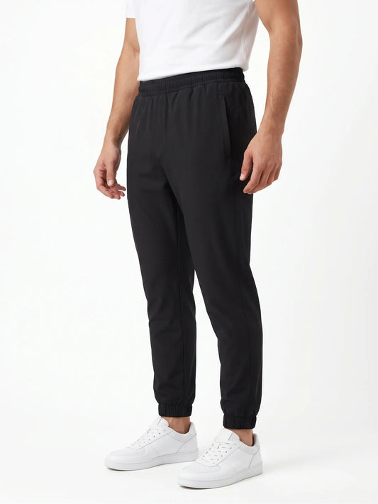 Back view of men's black 100% polyester athletic training sweatpants from TREE