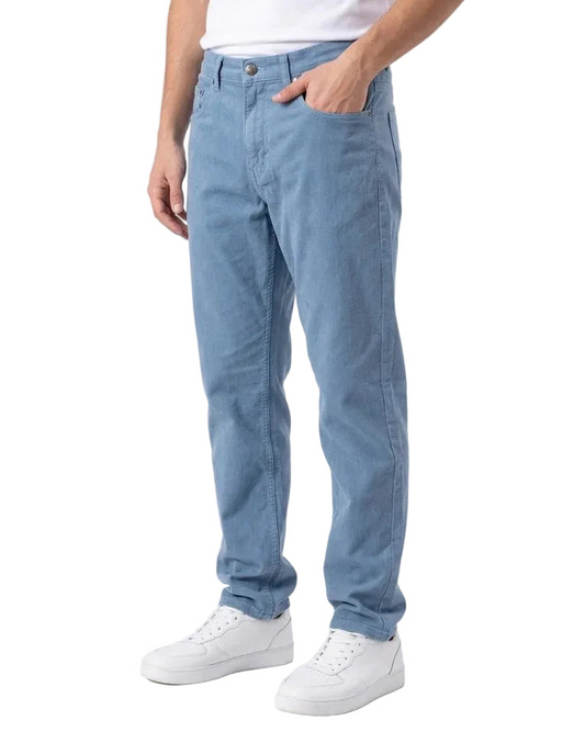 A person wearing light blue straight-leg jeans, a white t-shirt, and white sneakers, standing against a plain white studio background.