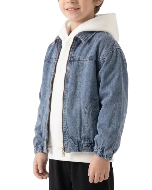 A child wearing a light blue denim jacket over a white zip-up hoodie and black pants, photographed against a plain white studio background.
