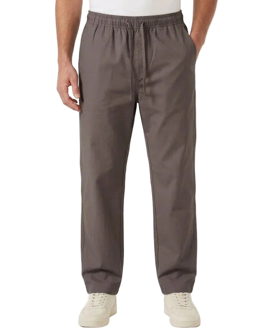 A person wearing dark gray drawstring pants with side pockets, paired with a white t-shirt and off-white sneakers, shown from the waist down on a white studio background.