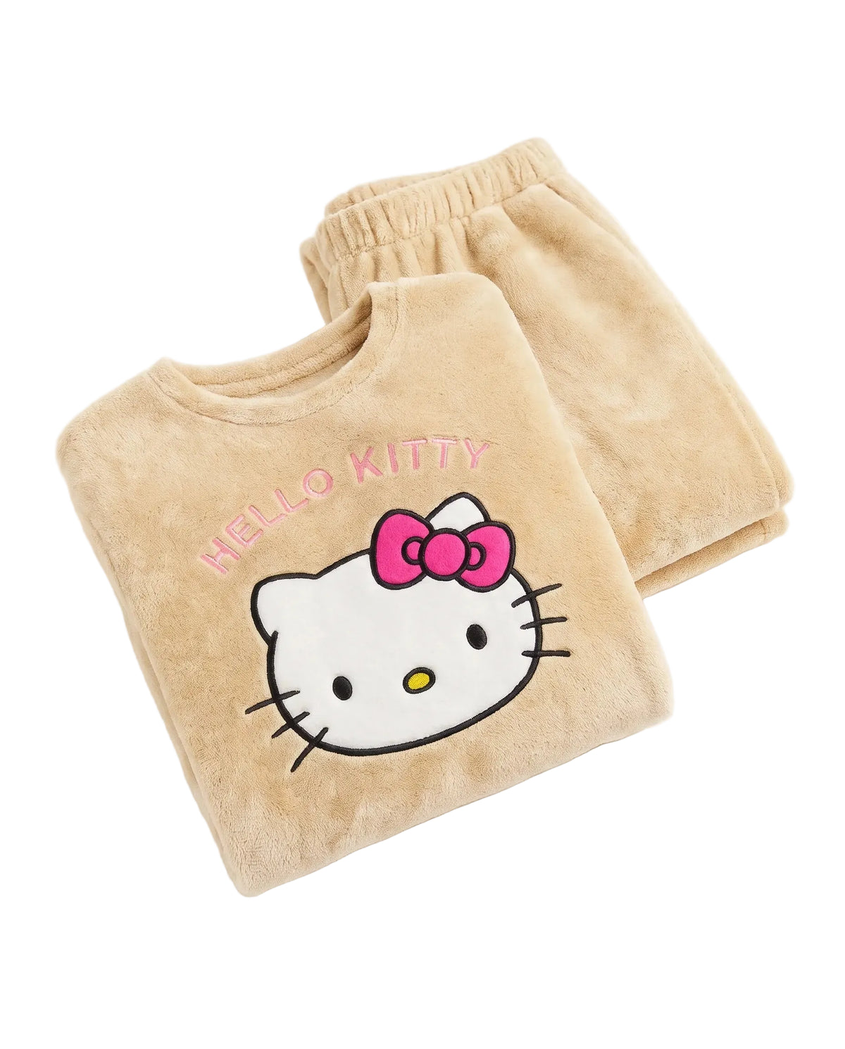 A beige plush pajama set featuring a folded long-sleeve top with a Hello Kitty face graphic, pink bow, and 'HELLO KITTY' text, paired with matching jogger pants on a white background.