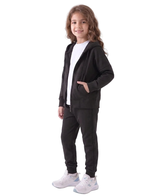Front view of a young girl wearing an oversized summer milton jacket in black by TREE.