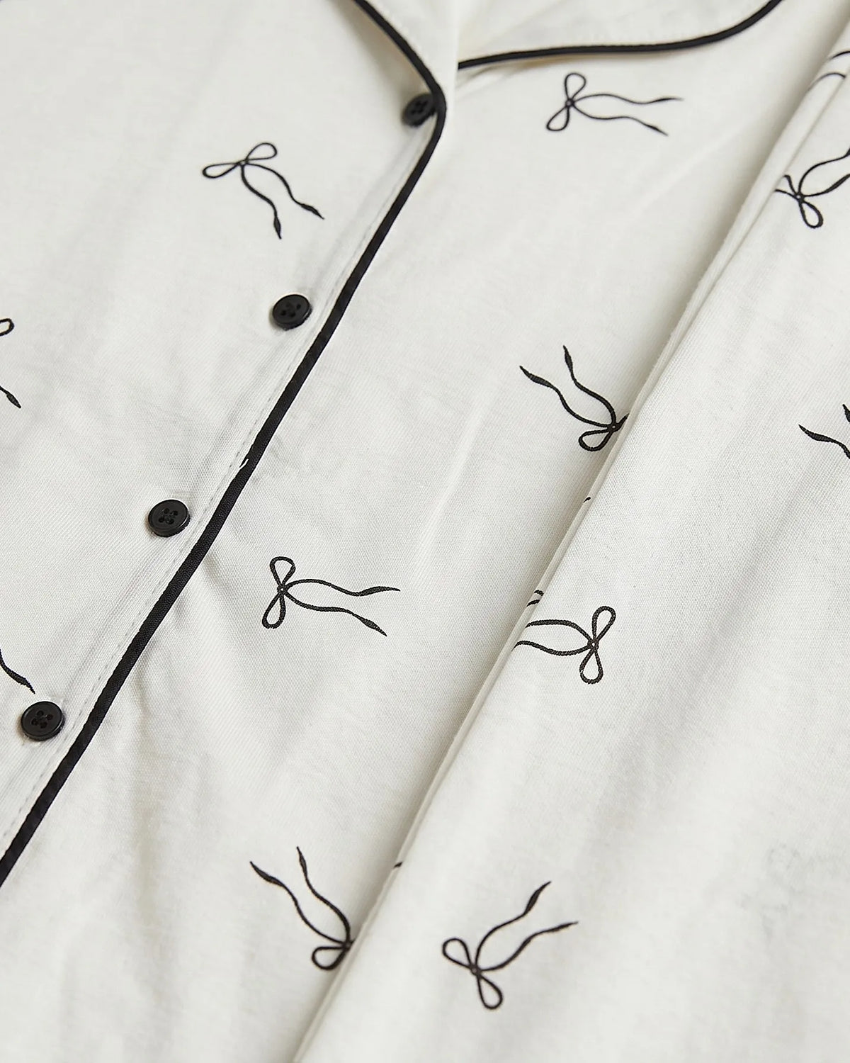 Women's classic printed pyjama set in off-white with black bow pattern by TREE   