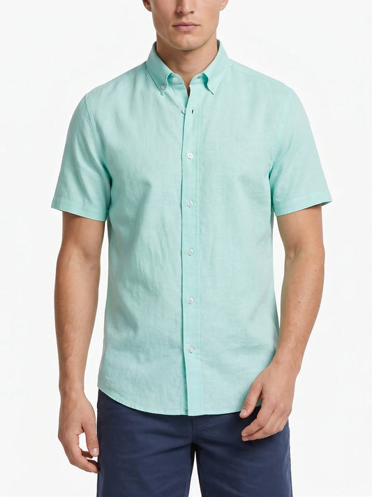 Front view of a man wearing a short-sleeve light pistachio oxford shirt by TREE.