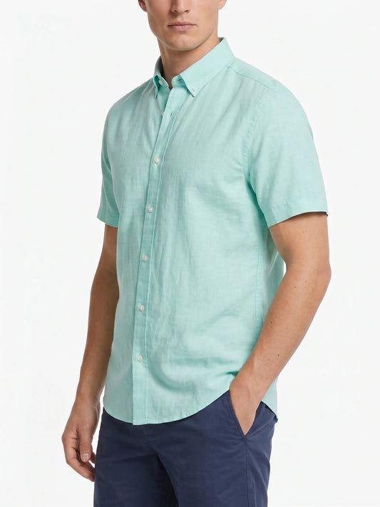 Front view of a man wearing a short-sleeve light pistachio oxford shirt by TREE.