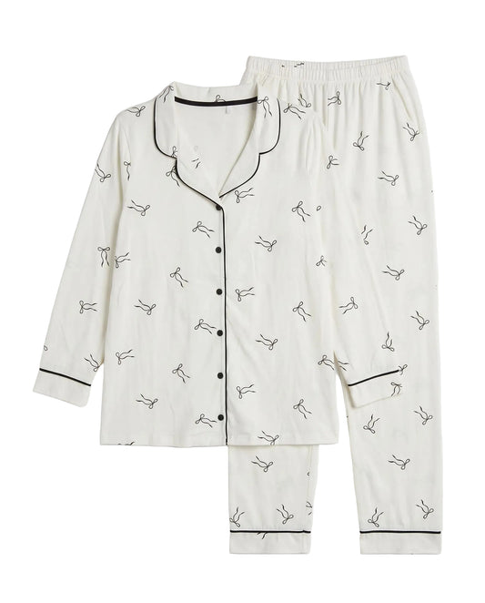 Girls' classic printed pyjama set in off-white with black bow pattern by TREE   