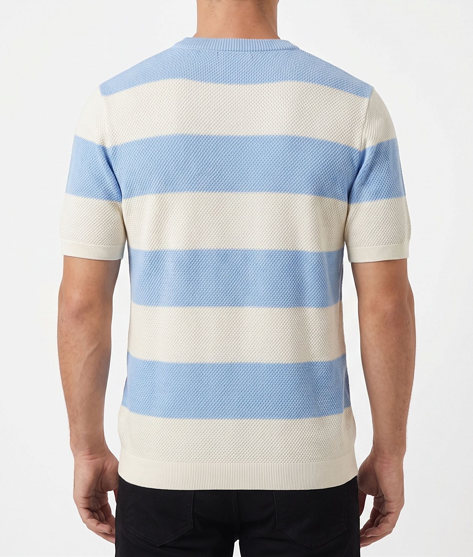 A man wearing a summer horizontal striped knit t-shirt with a textured finish and crew neck, paired with casual pants.