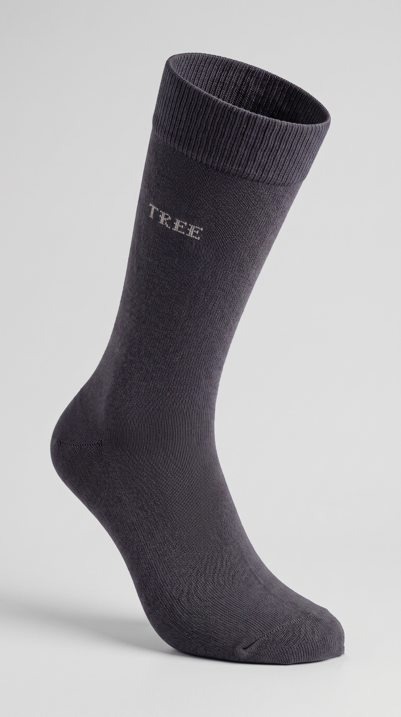 A single dark gray crew sock with the brand name 'TREE' printed in white on the side, displayed on a light gray background.