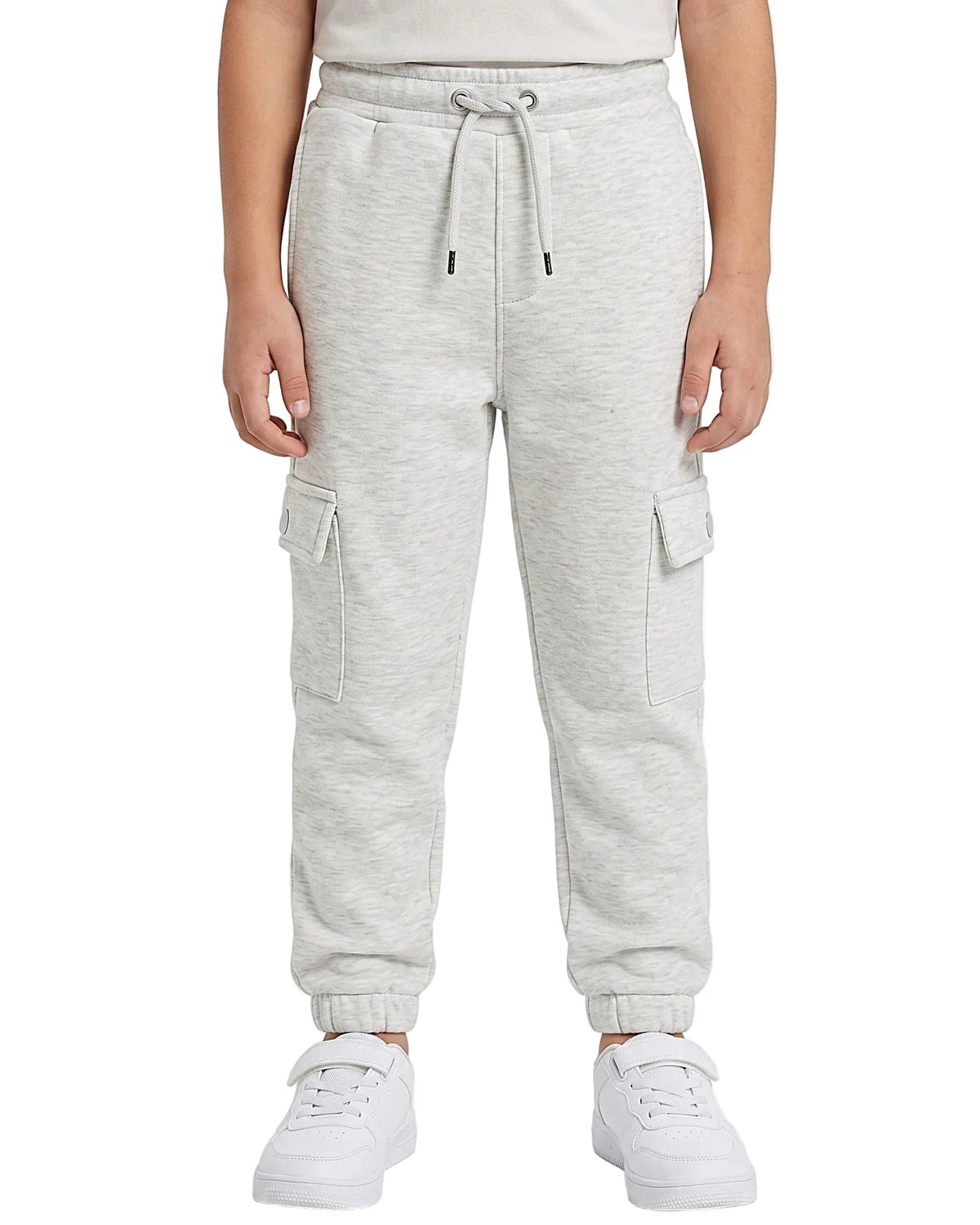 Multiple views of a boy wearing summer milton baggy cargo sweatpants featuring side pockets and a drawstring waist by TREE.