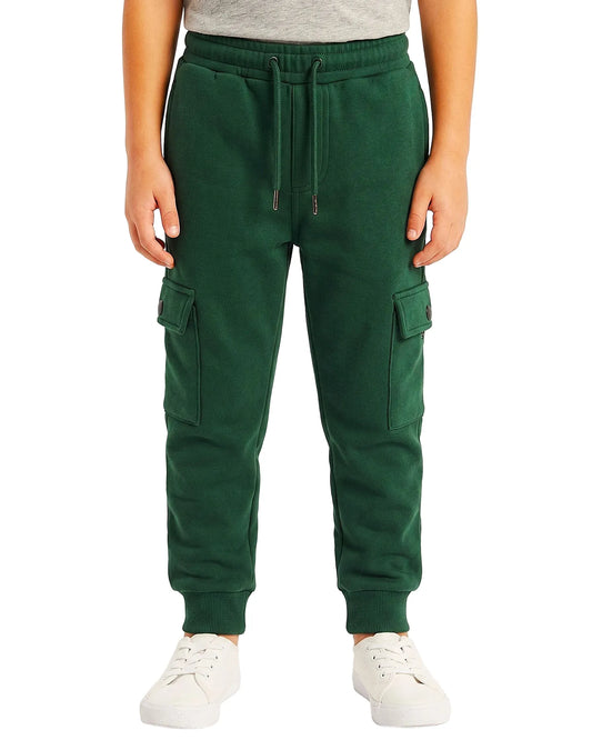 Multiple views of a boy wearing summer milton baggy cargo sweatpants featuring side pockets and a drawstring waist by TREE.