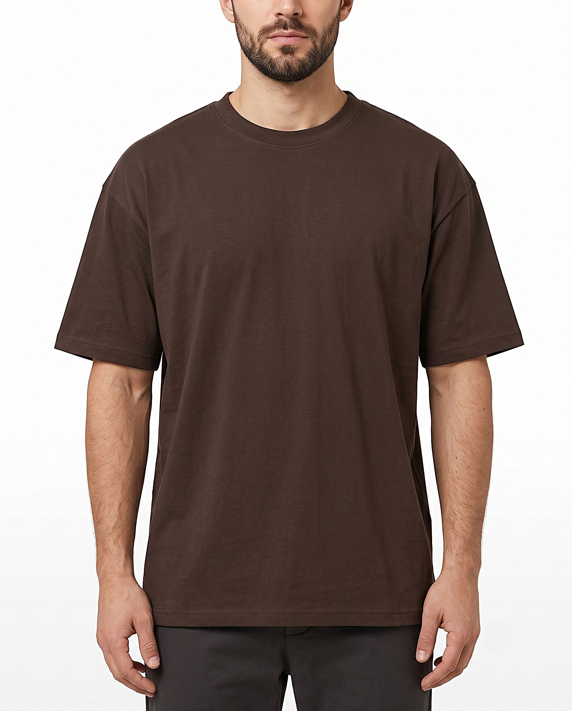 A man wearing a plain brown short-sleeve crewneck t-shirt, shown from the chin down against a light gray studio background.