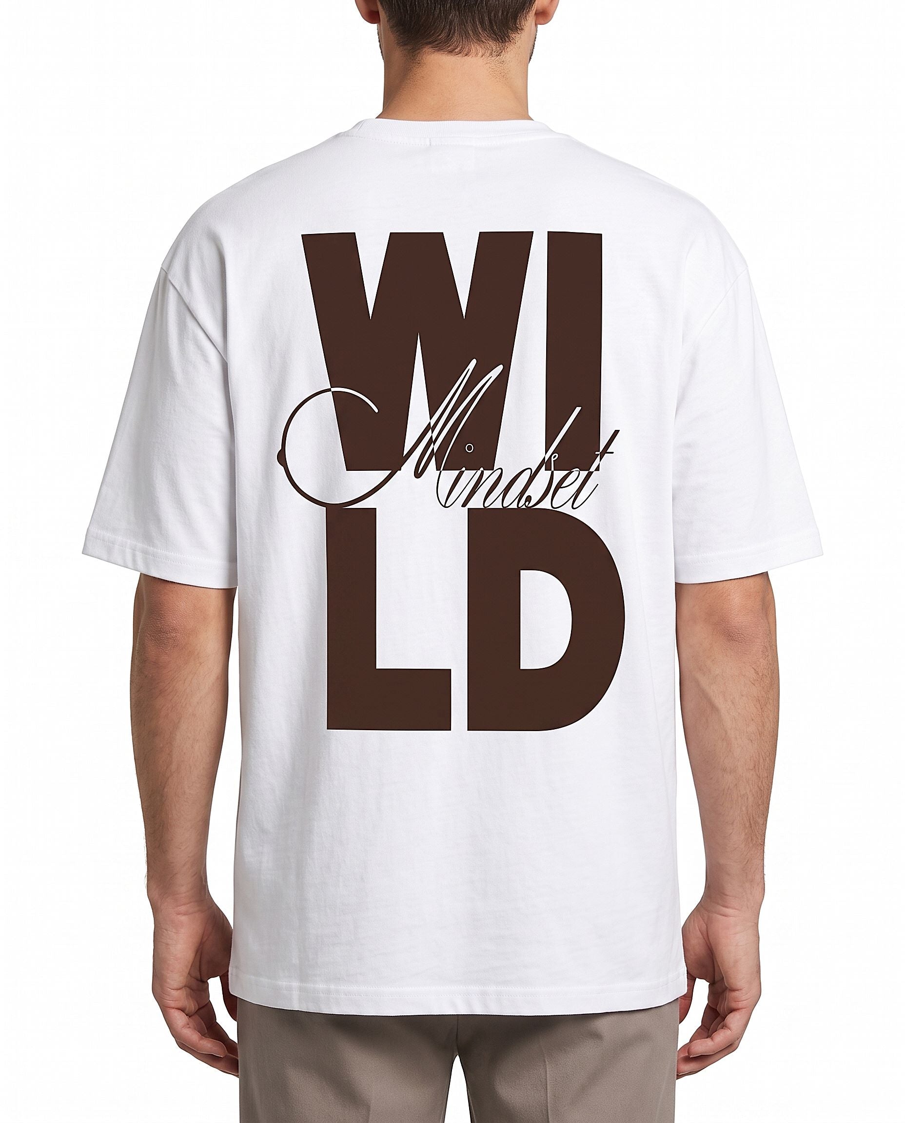 A man viewed from the back wearing a white t-shirt with a large brown graphic print reading 'WILD Ambition' on the back, paired with beige pants, against a plain white background.