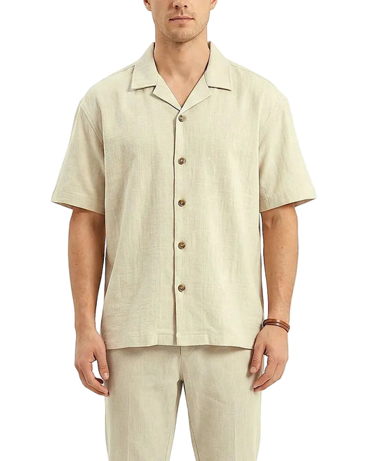 Front view of a men's solid beige casual shirt featuring a camp collar, short sleeves, and textured fabric in an oversized fit by TREE.