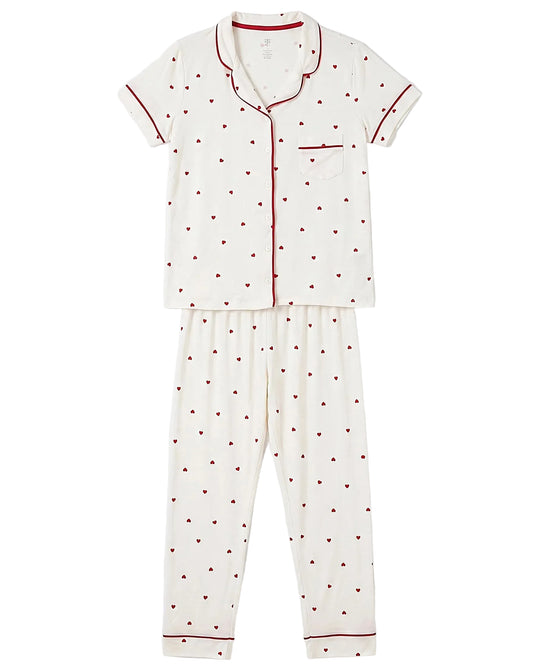 Front view of a women's creamy white pajama set featuring a red heart print and contrast piping by TREE.