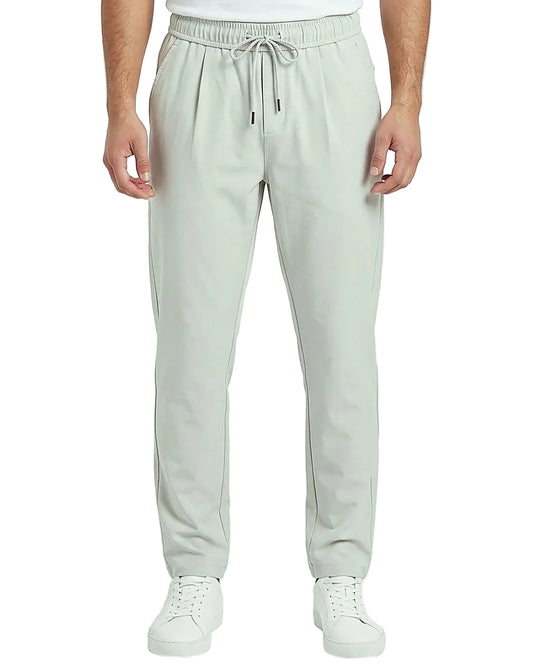 Back view of a men's beige regular-fit sarouel pants featuring an elastic waistband and structured pockets by TREE.
