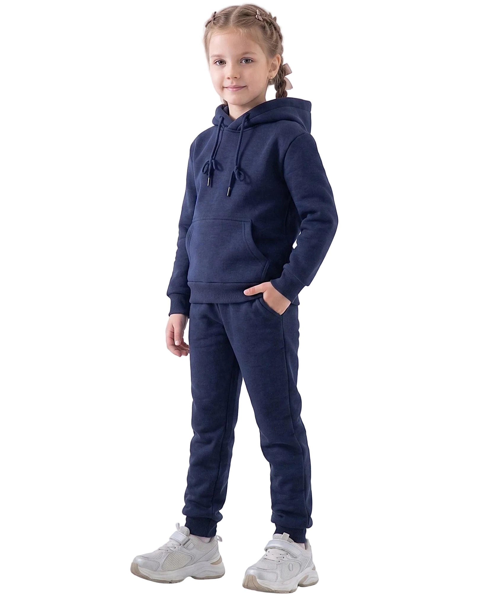 Front view of a young girl wearing navy pants in a relaxed fit by TREE.