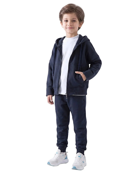 Full-body view of a boy modeling a matching dark navy kids' oversized milton cotton blend zip hoodie jacket and sweatpants by TREE