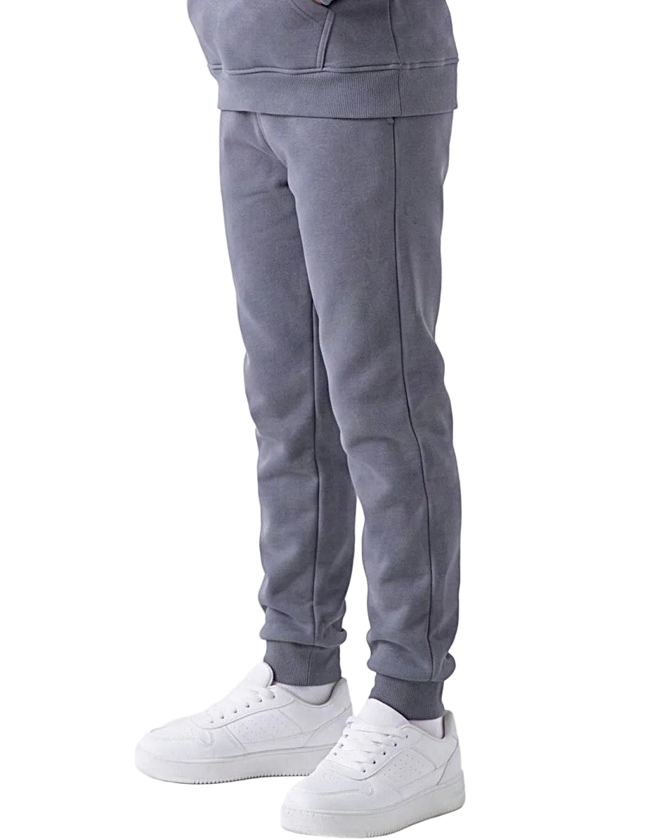 Front view of a young girl wearing dark grey milton pants in a relaxed fit by TREE.