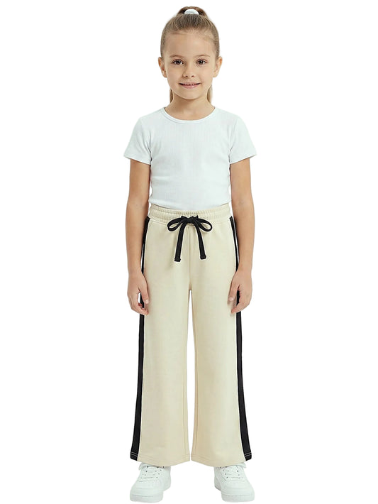 Front view of a young girl wearing girls' summer side-stripe wide-leg pants featuring an elastic waist and drawstring tie by TREE.