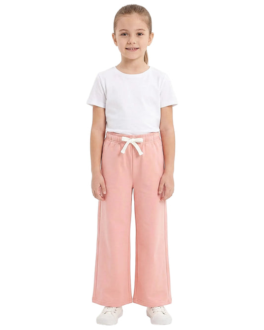 Front view of a young girl wearing girls' summer wide-leg pants featuring an elastic waist and drawstring tie by TREE.