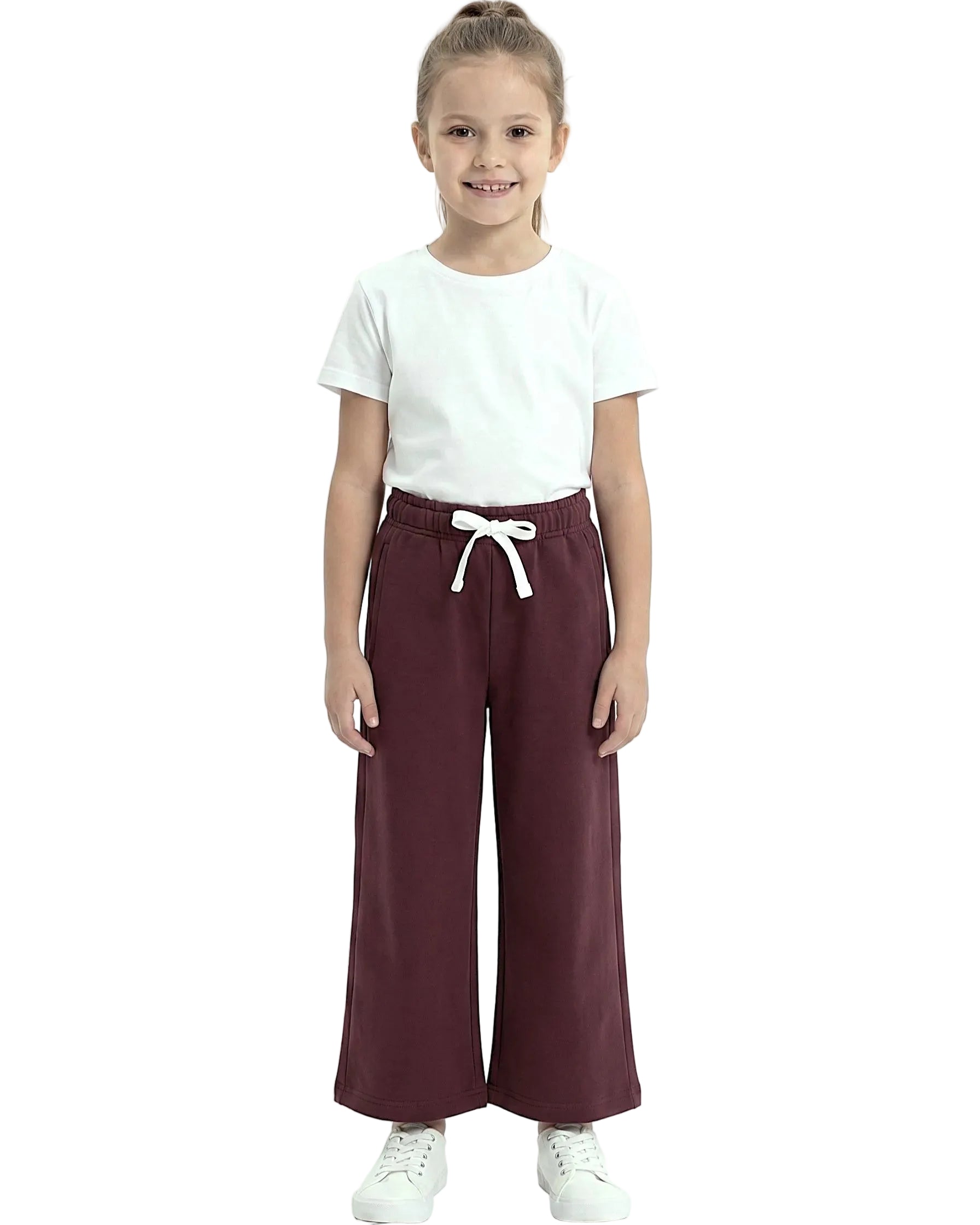 Front view of a young girl wearing girls' summer wide-leg pants featuring an elastic waist and drawstring tie by TREE.