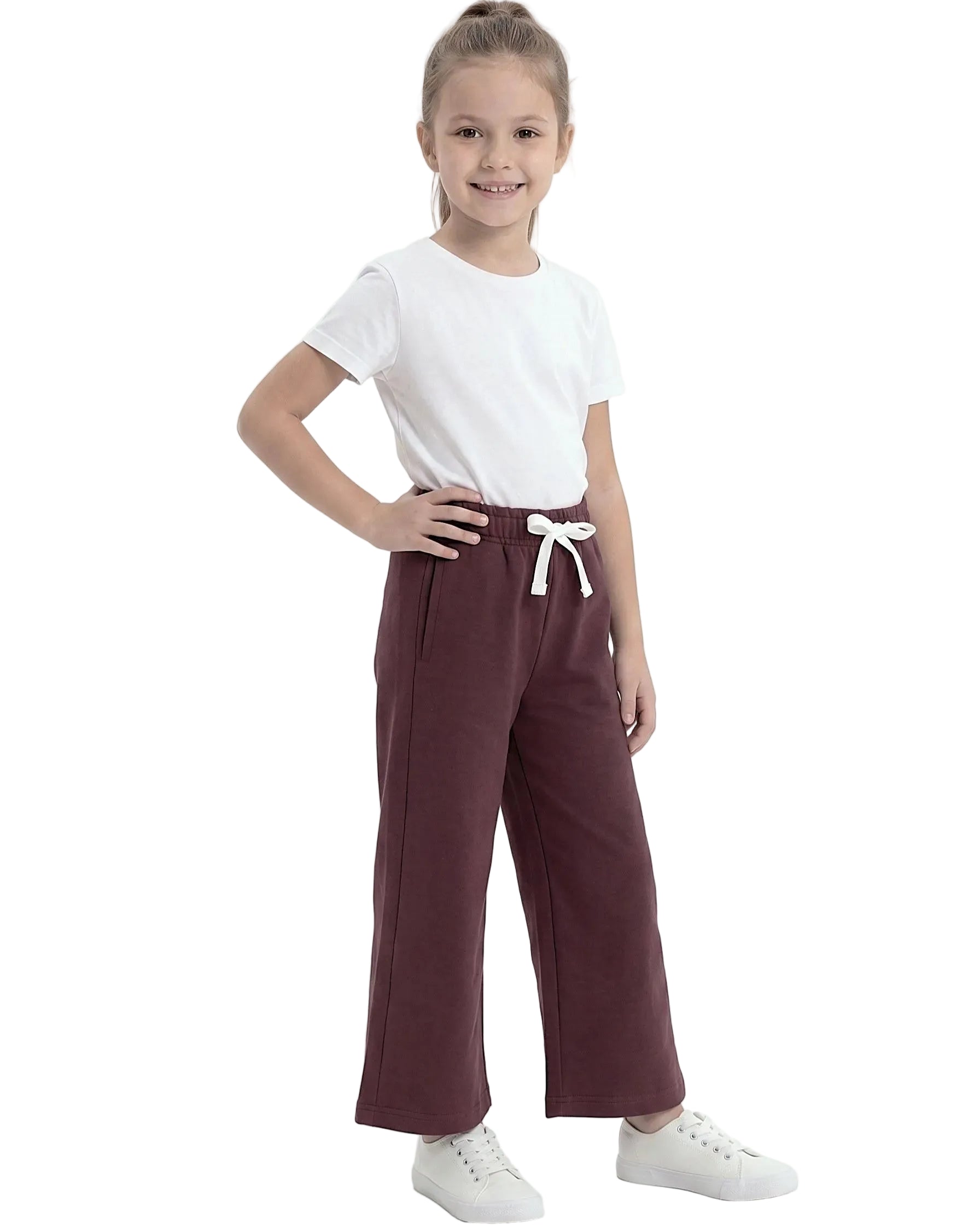 Front view of a young girl wearing girls' summer wide-leg pants featuring an elastic waist and drawstring tie by TREE.