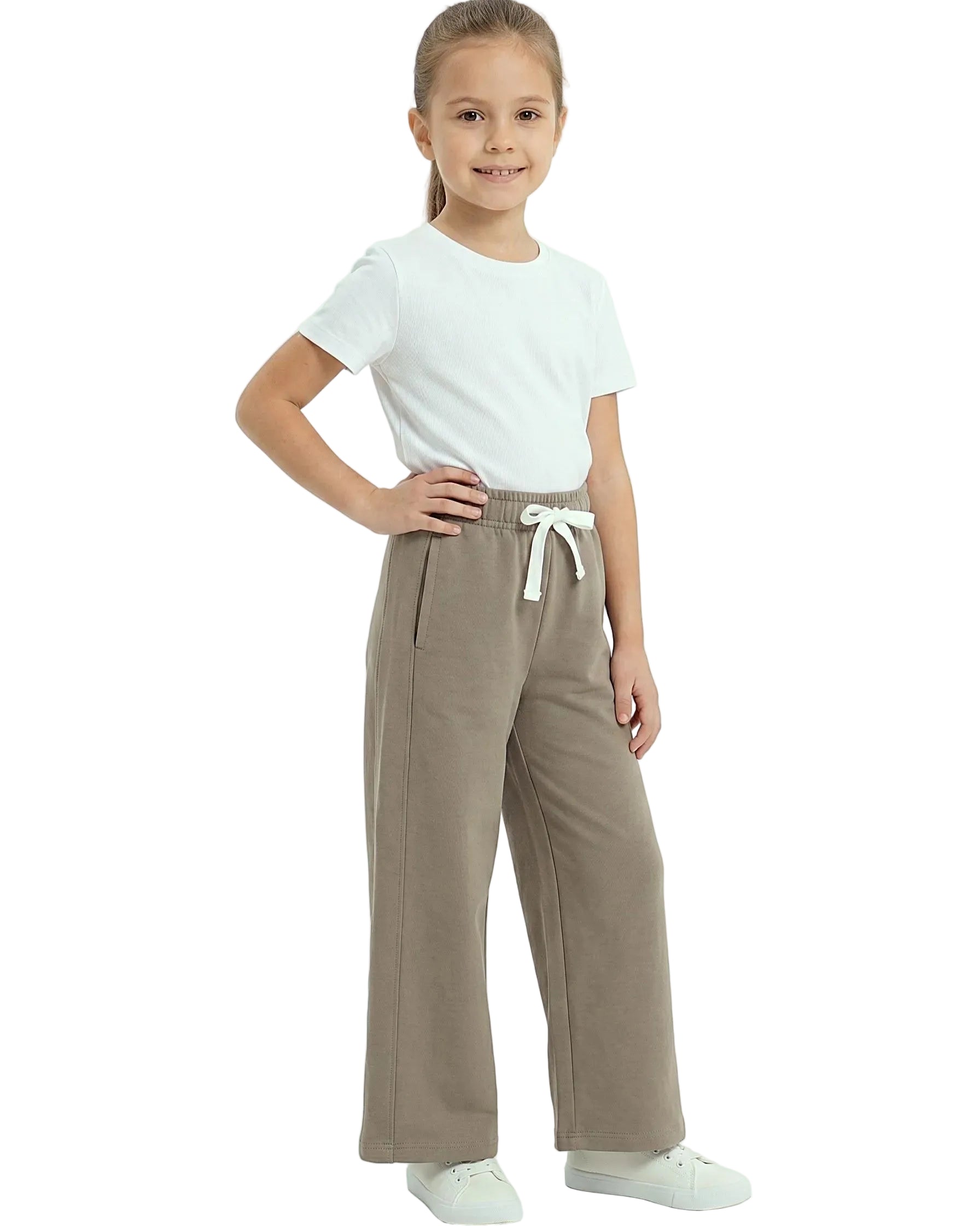 Front view of a young girl wearing girls' summer wide-leg pants featuring an elastic waist and drawstring tie by TREE.